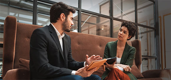 Two business people looking at an iPad and going over their options