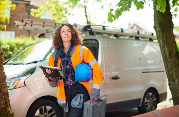 A handyman professional with equipment in her hands