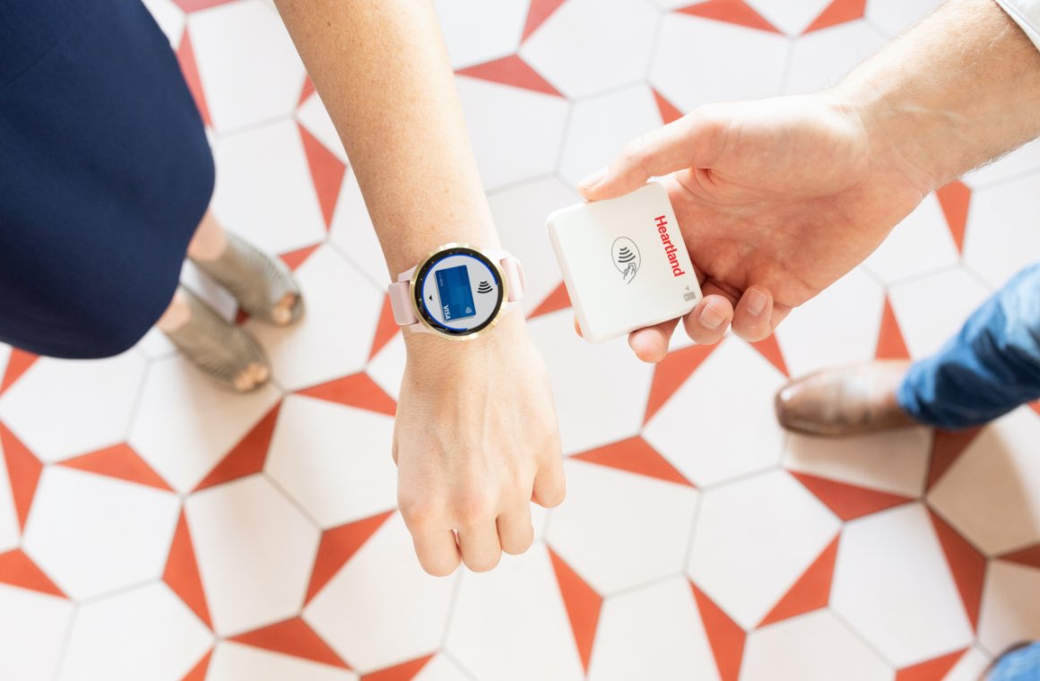 A customer making a payment via mobile wallet on a watch