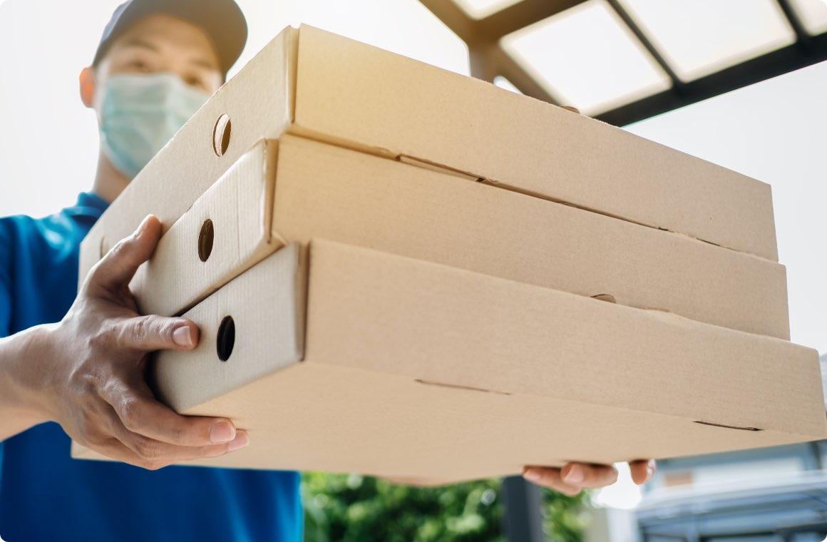 A man delivering pizza boxes