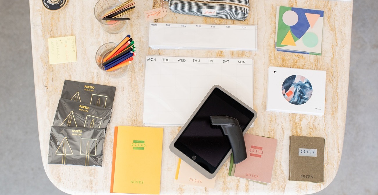 ACH Fraud Detection and Prevention  - Notebooks, barcode scanner, and tablet on a table