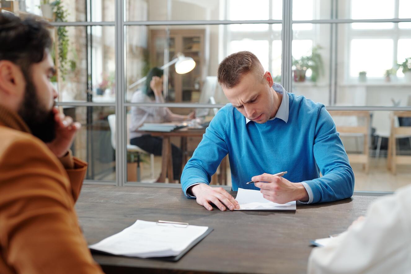 man filling out paperwork at a desk