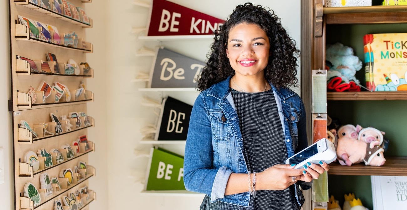 how to check your business credit - woman standing in front of a shelf