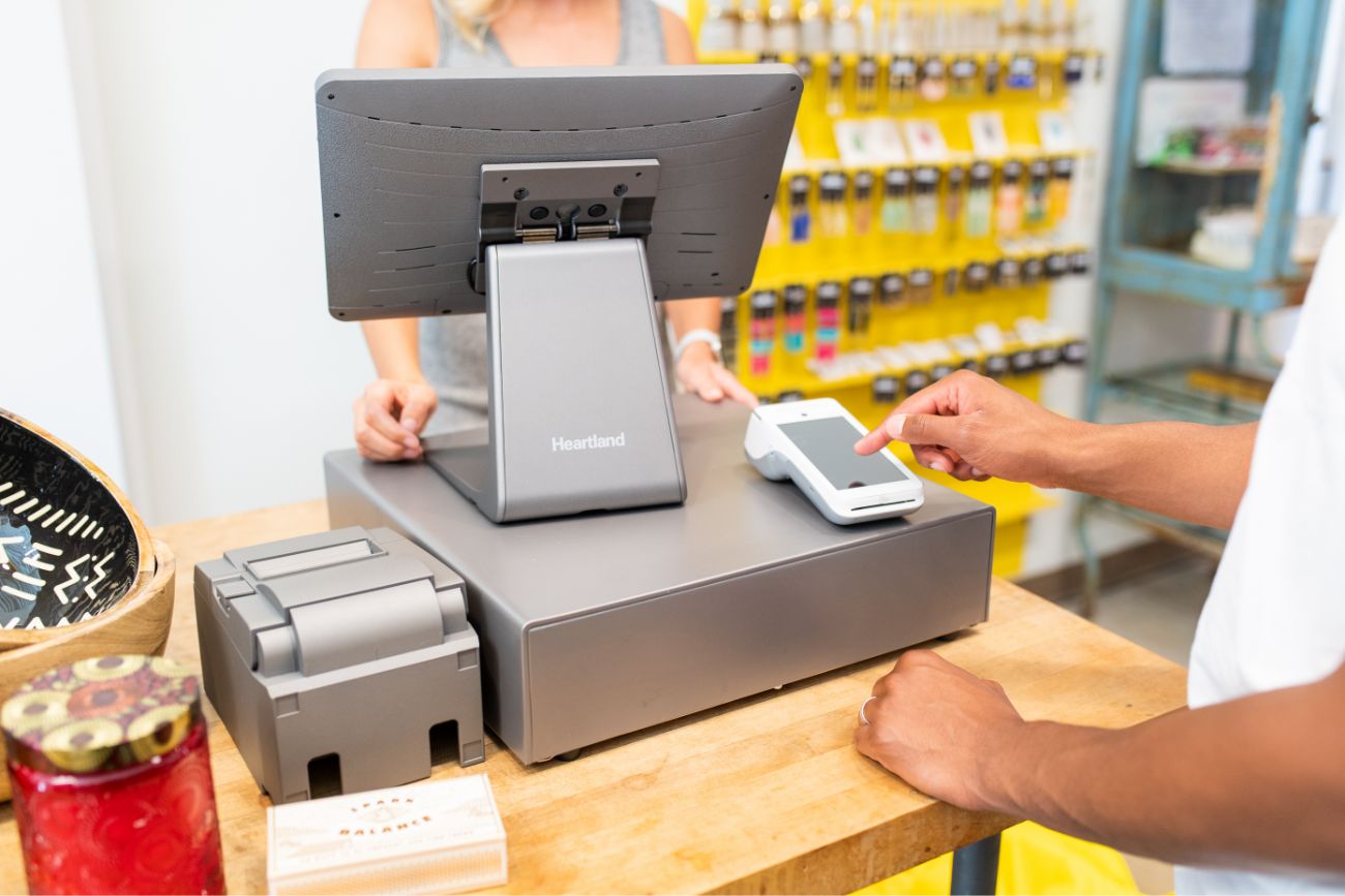 A customer using the touch screen of a handheld POS device. 