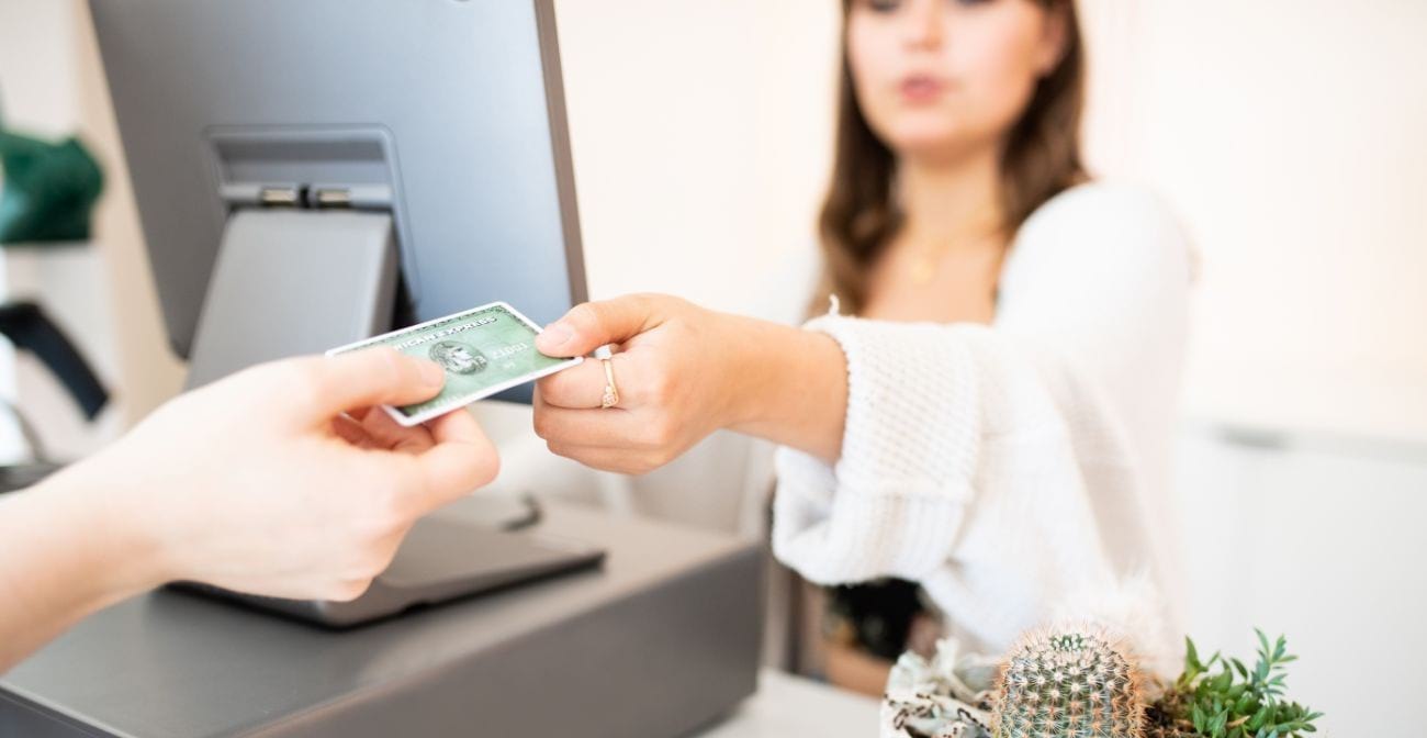How To Pick The Right POS System for Your Gas Station or C Store  - woman being handed a credit card