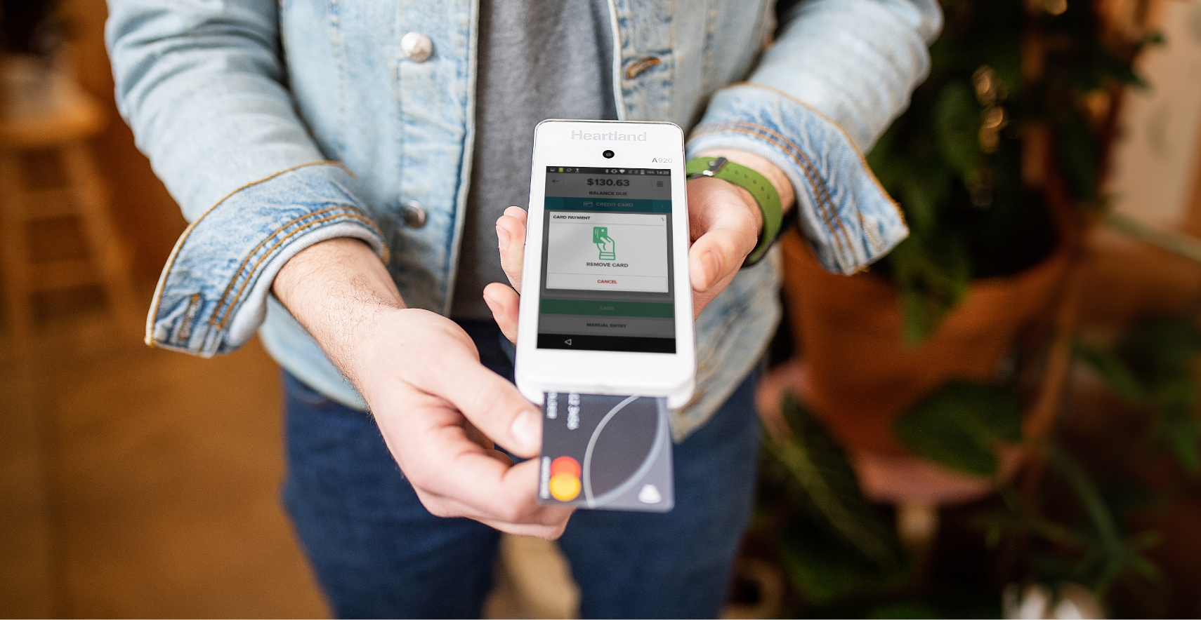 Key Differences Between a Payment Gateway & Payment Processor - person inserting EMV chip credit card into terminal