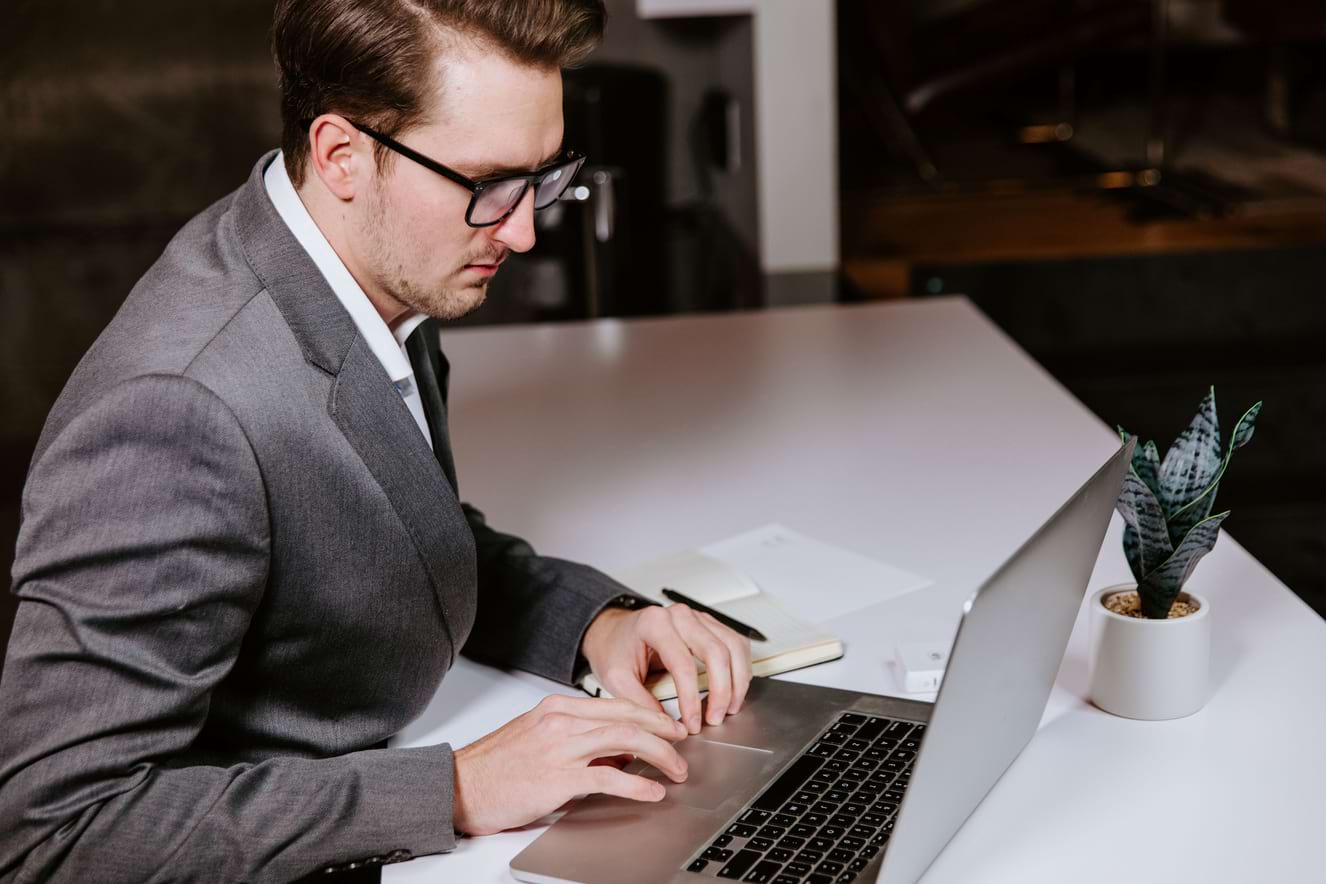 man typing on latop computer 