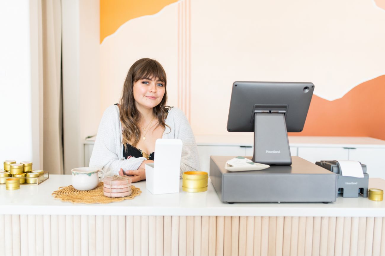 A employee standing at the counter smiling. 