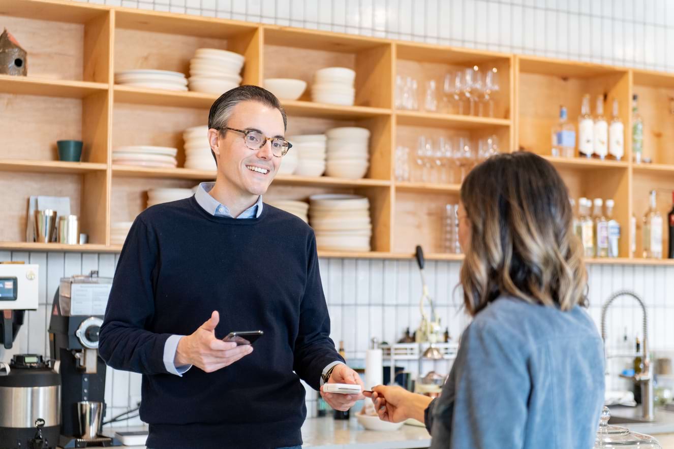 man and woman talking in a store