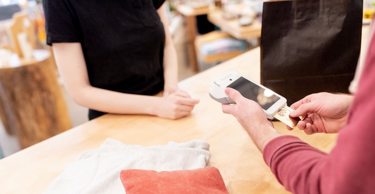 six steps to prevent credit card fraud - woman with card inserted in a credit card reader