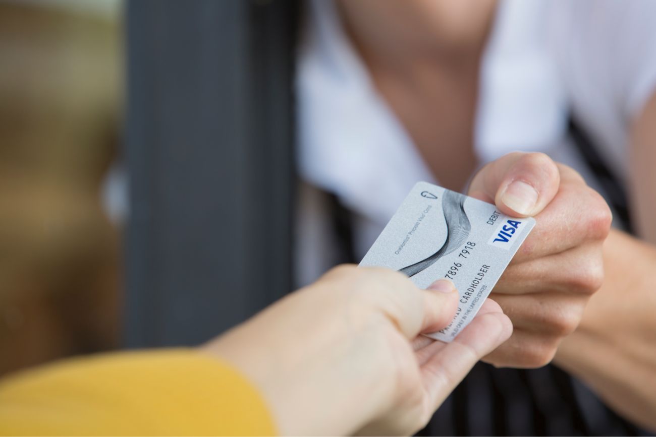A credit card exchange between two peoples hands.
