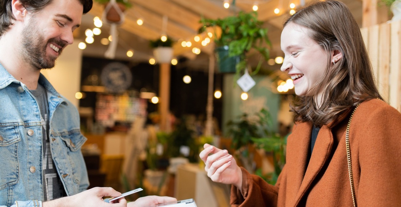 What to Do if You Suspect Credit Card Fraud by a Customer - man accepting a credit card from a woman