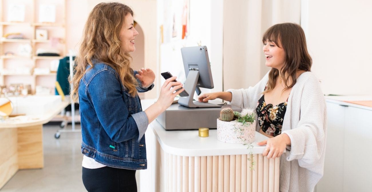 Why Omnichannel Commerce is The Future of Business - two women talking at a checkout counter