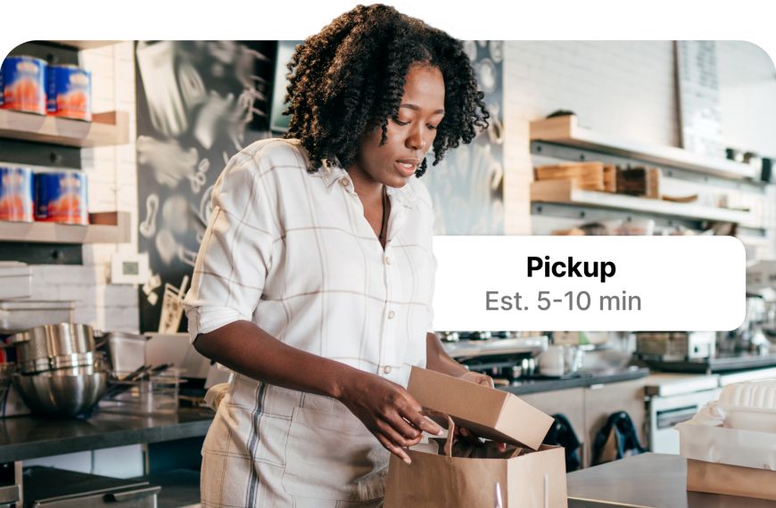 Female bakery employee packing up a to-go order