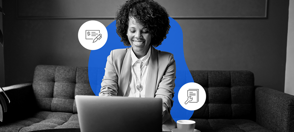 A woman working on a laptop and smiling