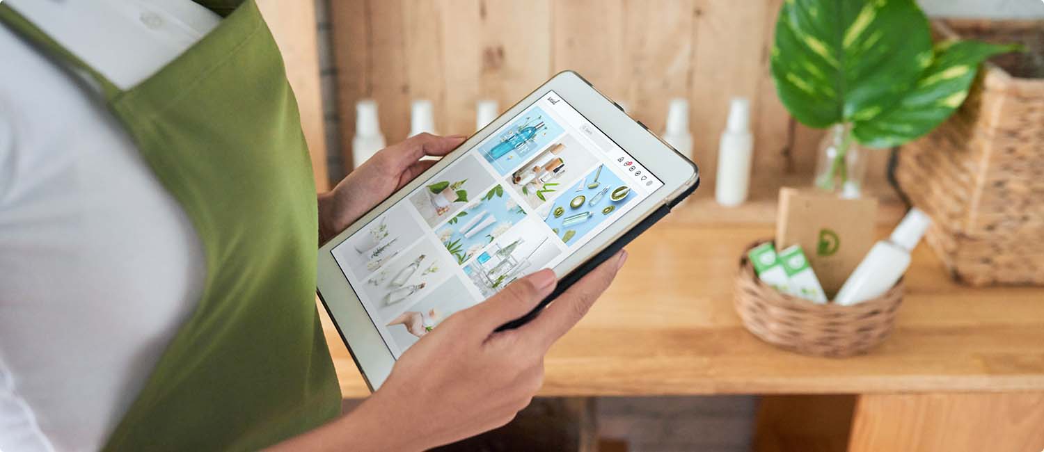 Photo of a retail worker holding a tablet with images of products