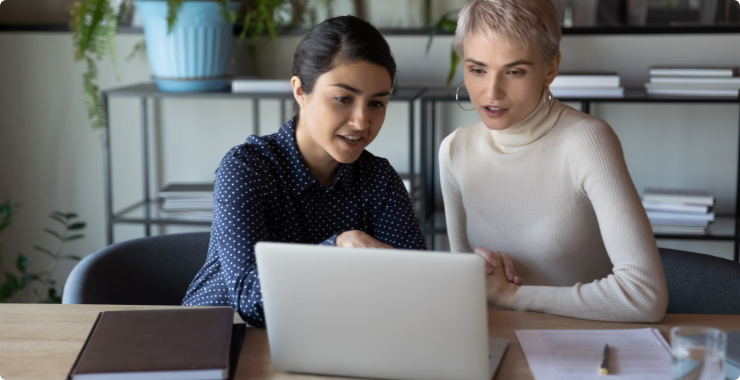 Two women looking at a laptop screen
