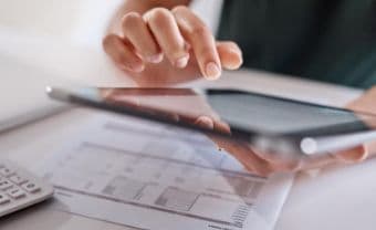 Woman looks at cash flow statement on tablet