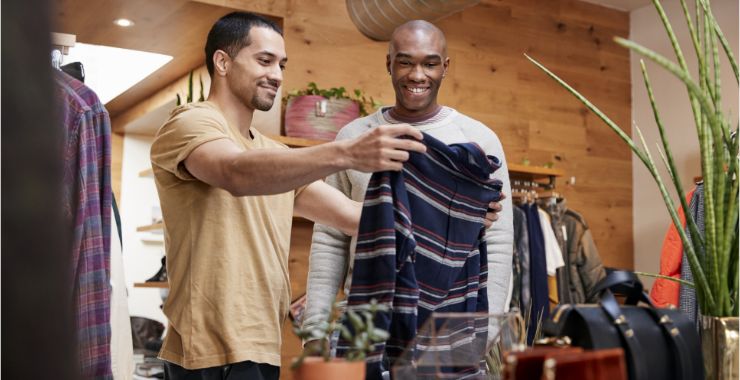 Two men shopping for sweaters in a clothing store