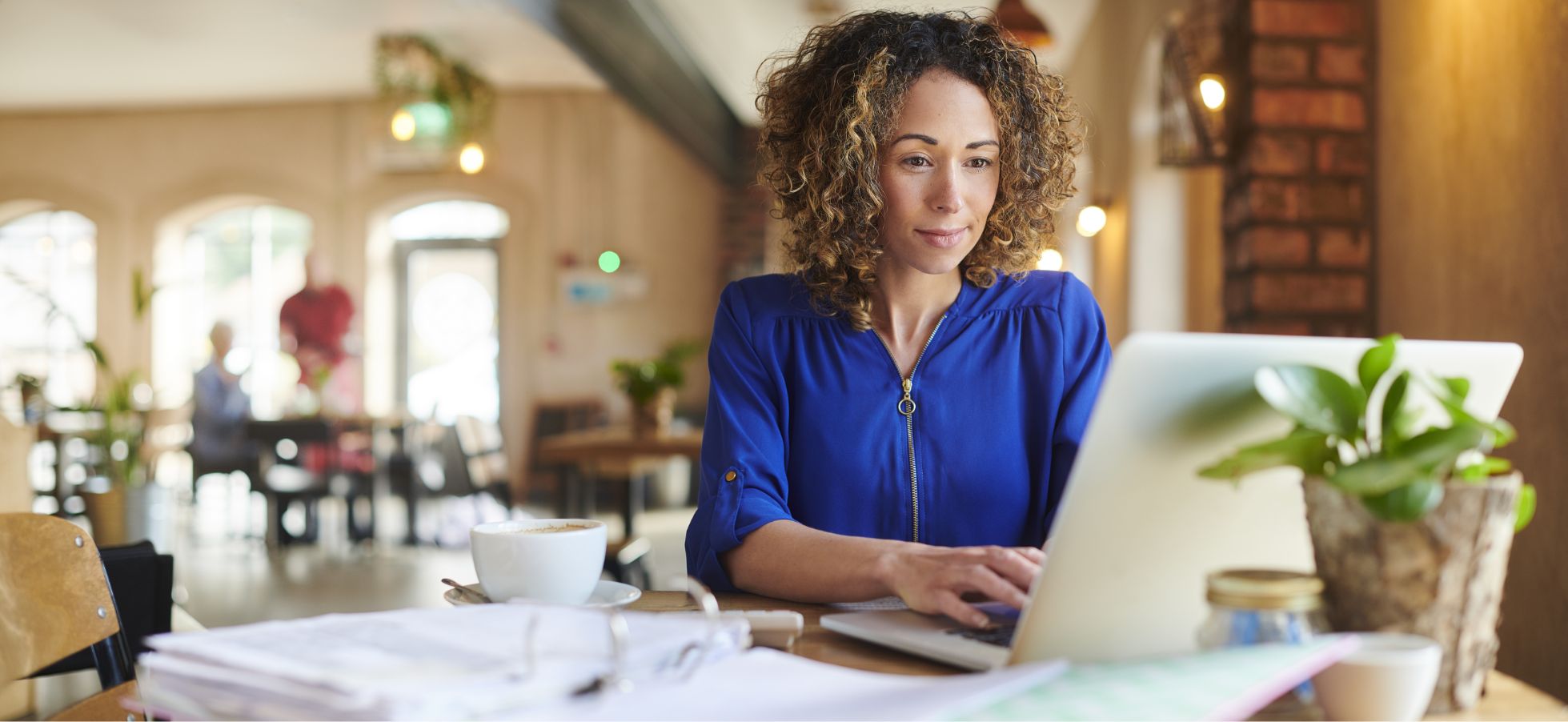 A business owner sits in front of a laptop.