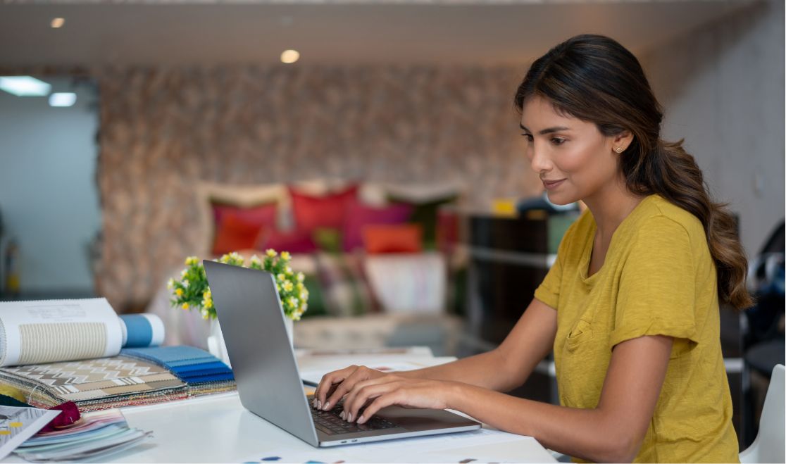Woman using a laptop to run retail buying reports